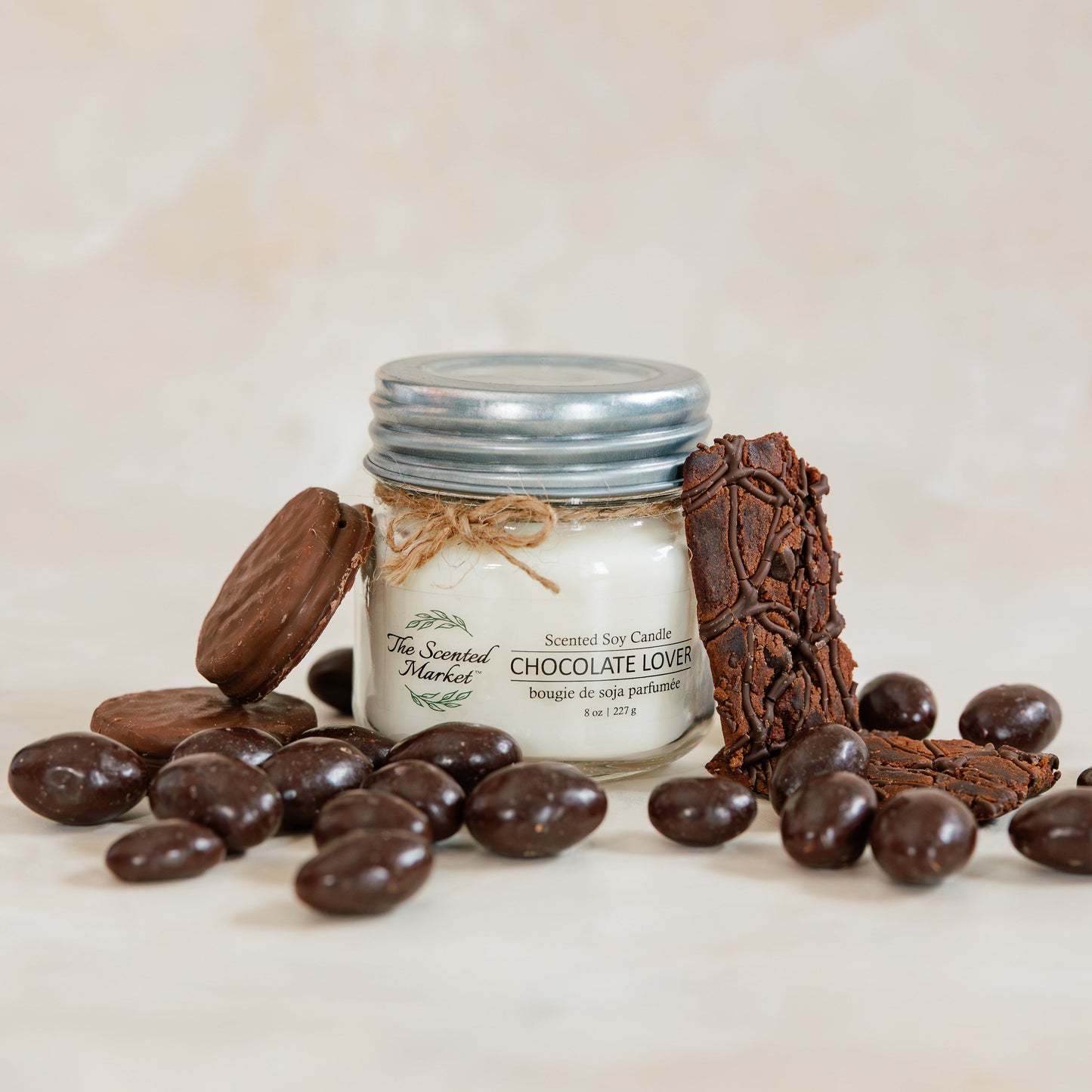 Jar of chocolate truffles with chocolate pieces on a light background